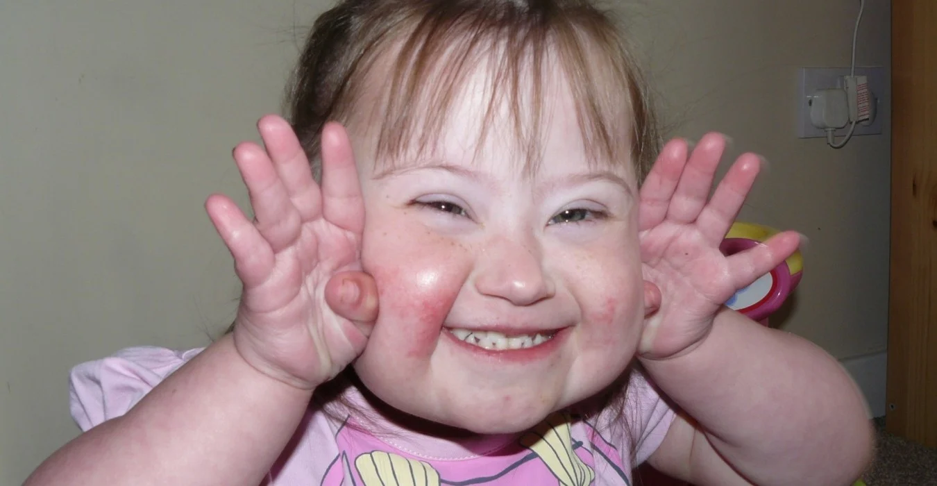 A smiling young girl at Tiny Tim's Children's Centre